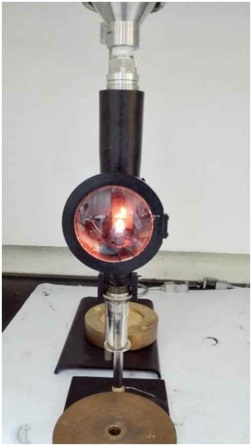A laminar diffusion flame burning on the group's wick-fed burner, used for soot generation and smoke-point measurement.